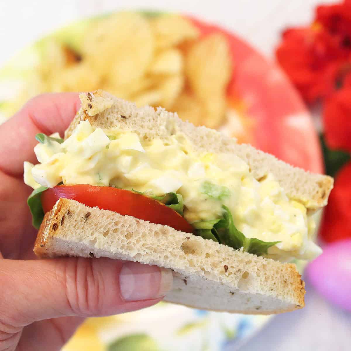 Holding half a sandwich.