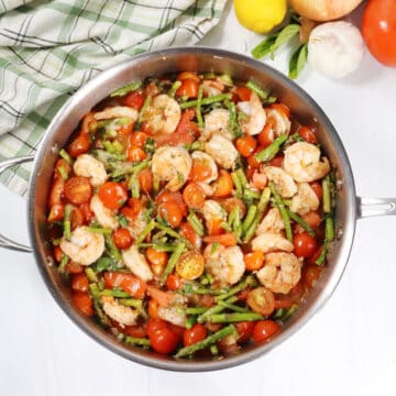 Spaghetti Squash Primavera with shrimp in skillet.