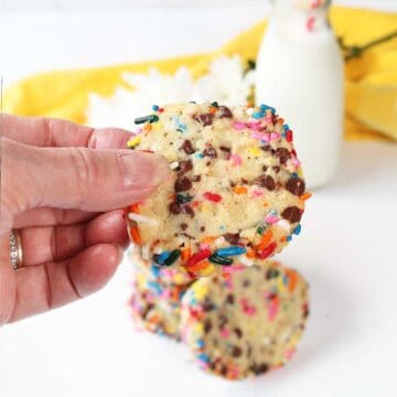 Holding a cream cheese cookie over counter.