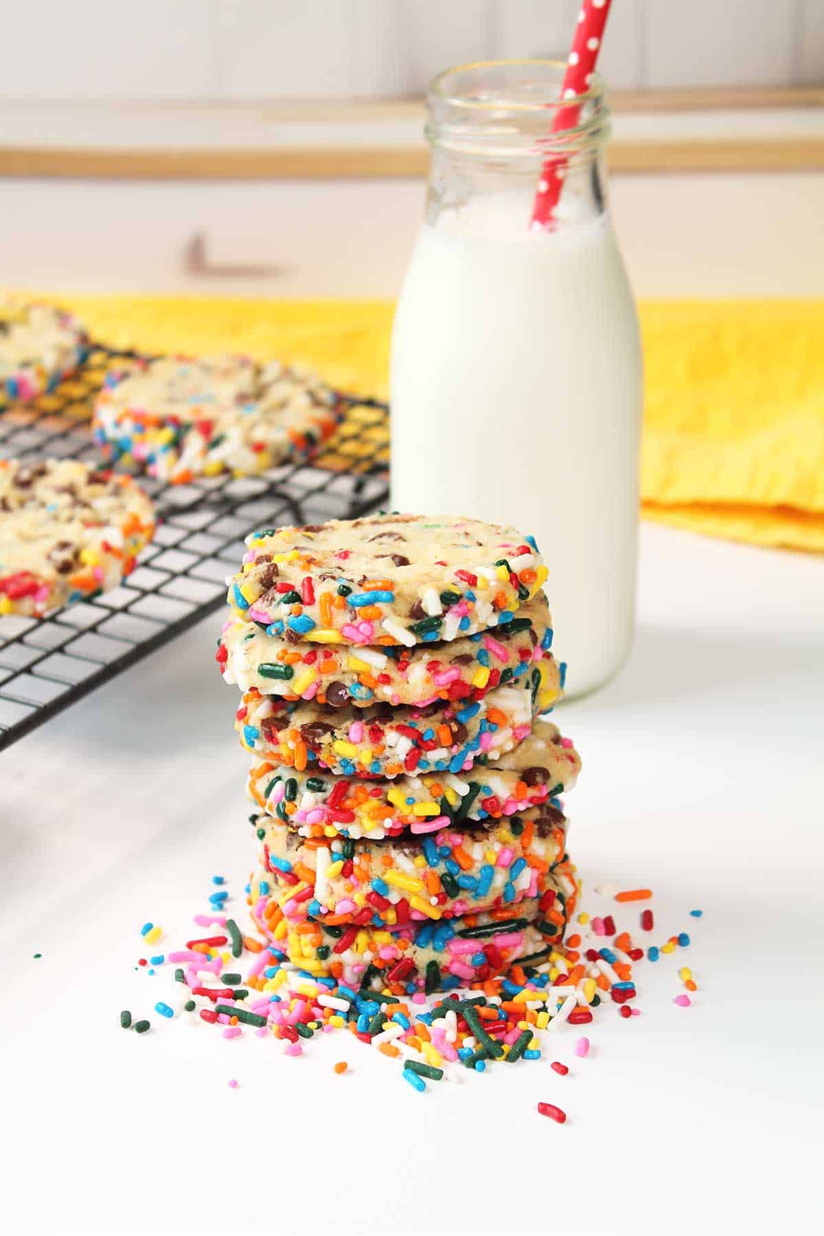 Chocolate Cheesecake Cookies stacked by milk bottle.