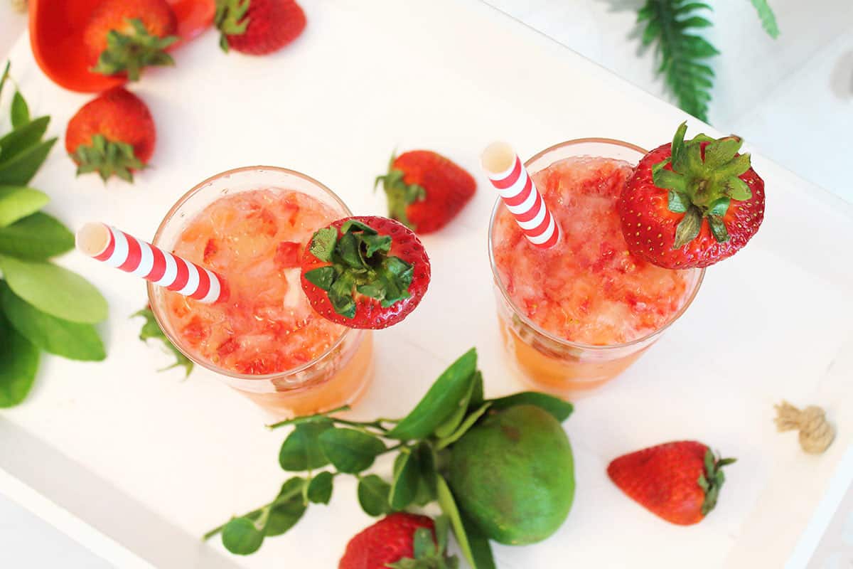 Overhead of two rum cocktails with strawberries.