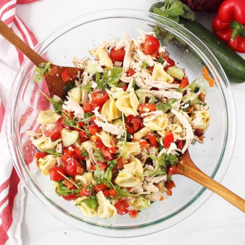 Tossed Chicken Tortellini Salad in glass bowl.