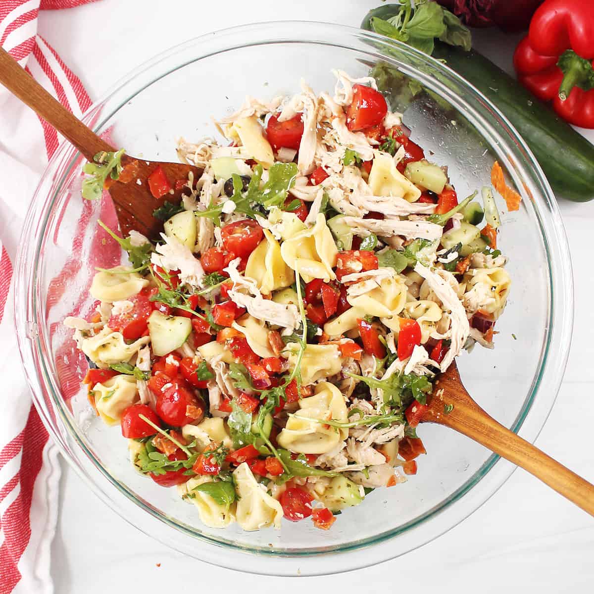 Tossed Chicken Tortellini Salad in glass bowl.