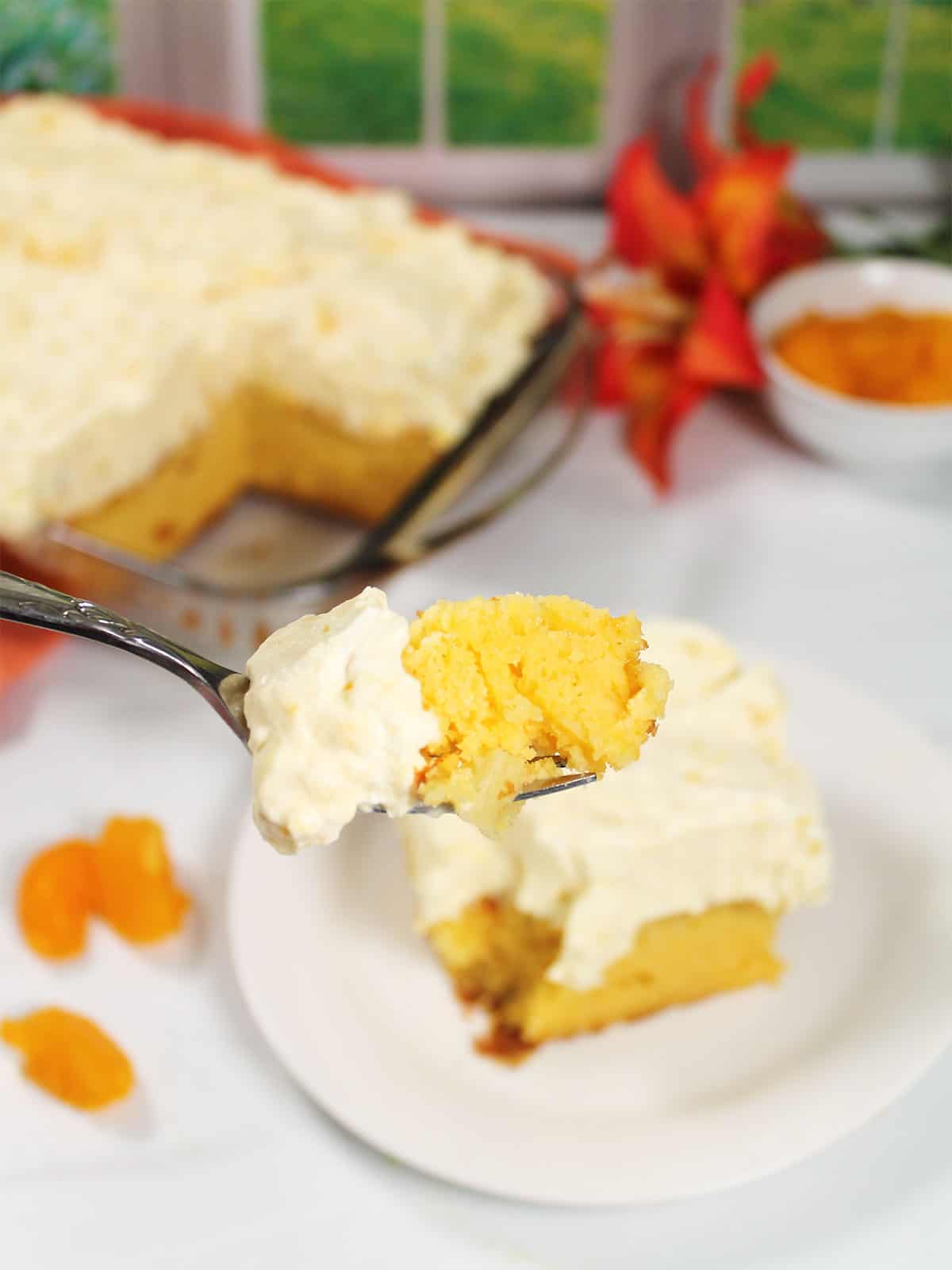 Bite of mandarin orange pineapple cake on a fork.