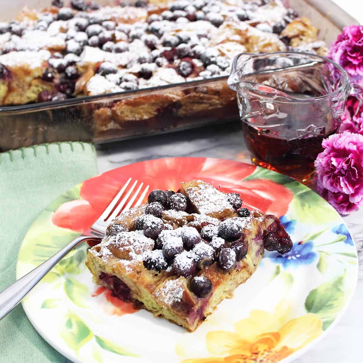 Serving on spring flowered plate with syrup and casserole.