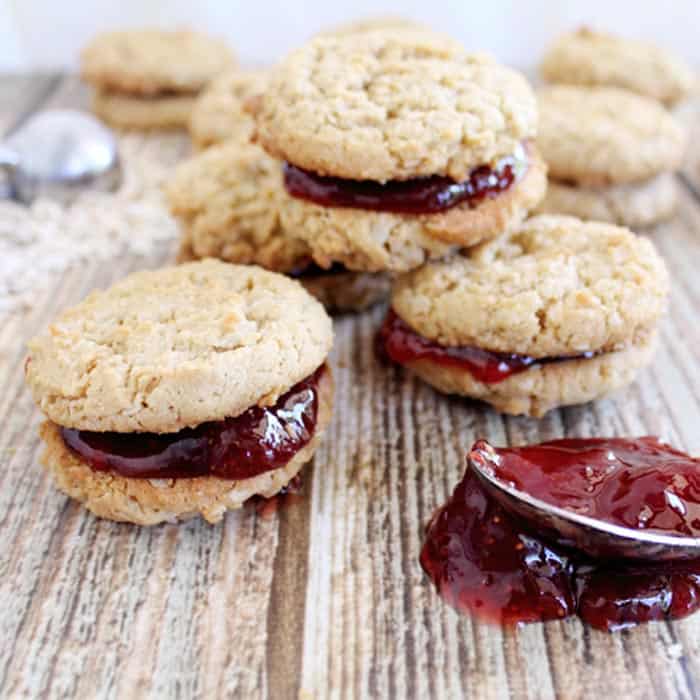 Peanut butter and jelly cookies on wooden table.