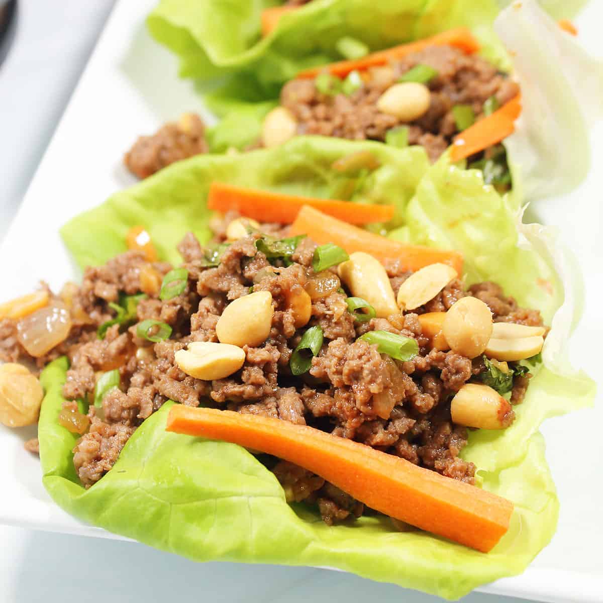 Asian Beef Lettuce Wraps closeup with garnishes.