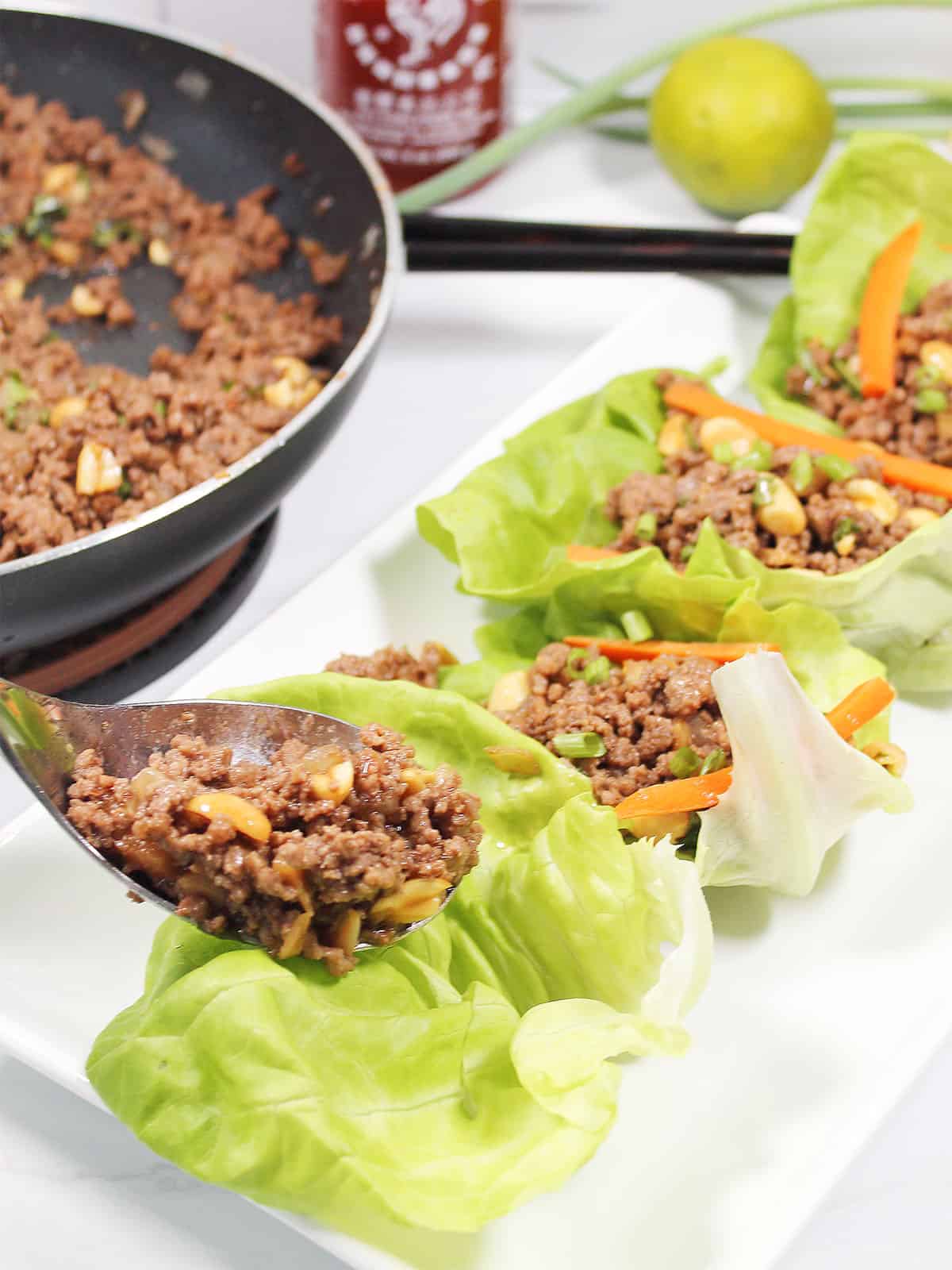 Spoon filling into lettuce.