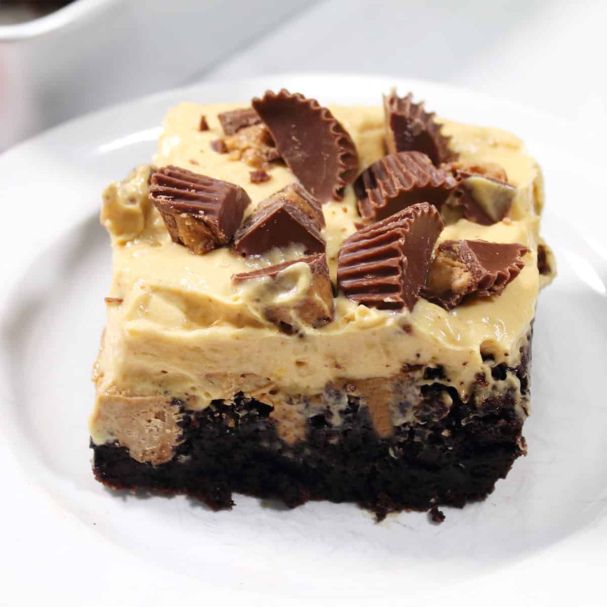 Closeup of brownie poke cake cut into square.
