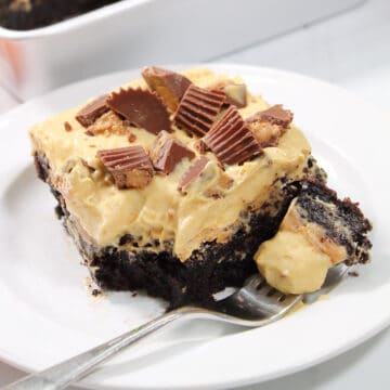 Slice of brownie poke cake with bite on fork.