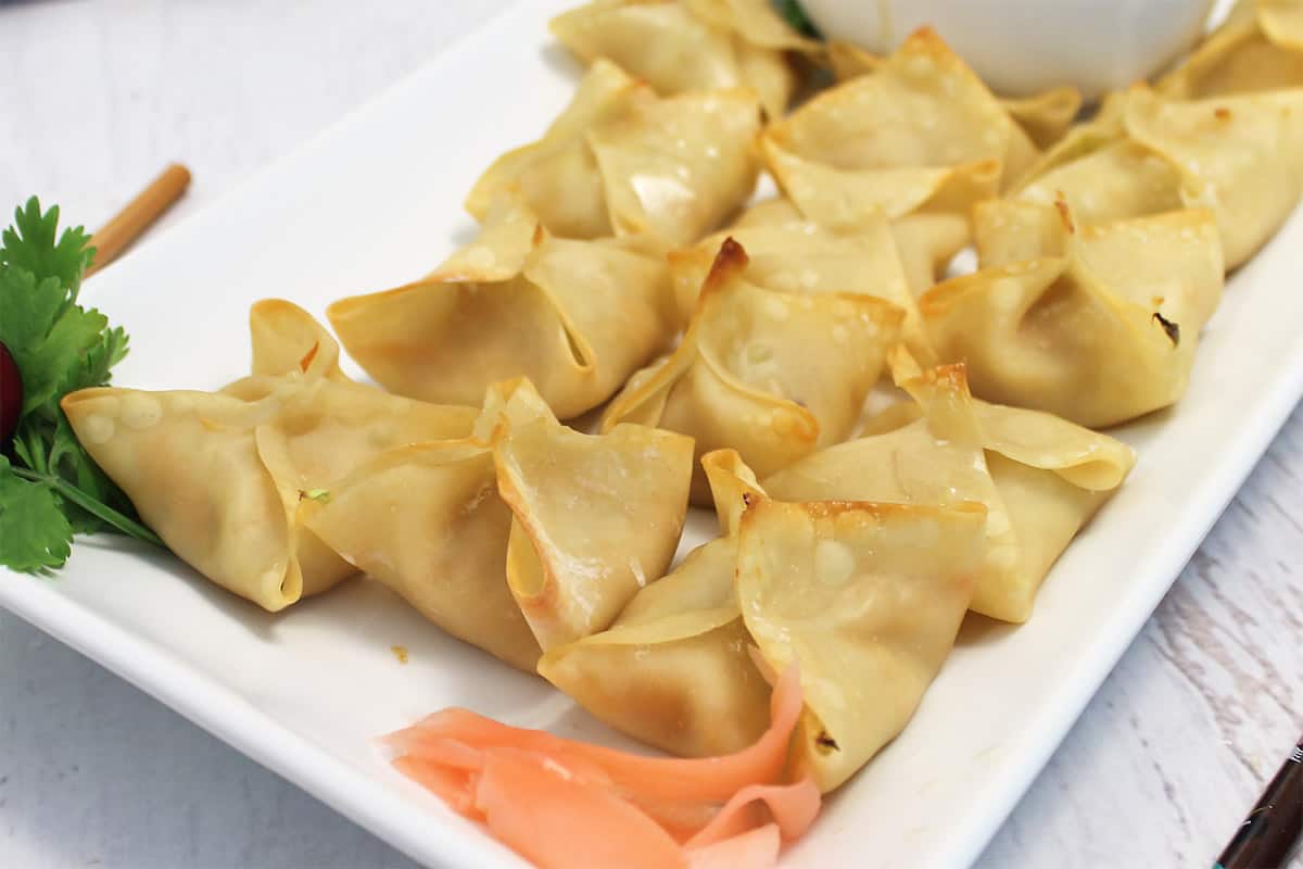 Closeup of filled wontons on platter.