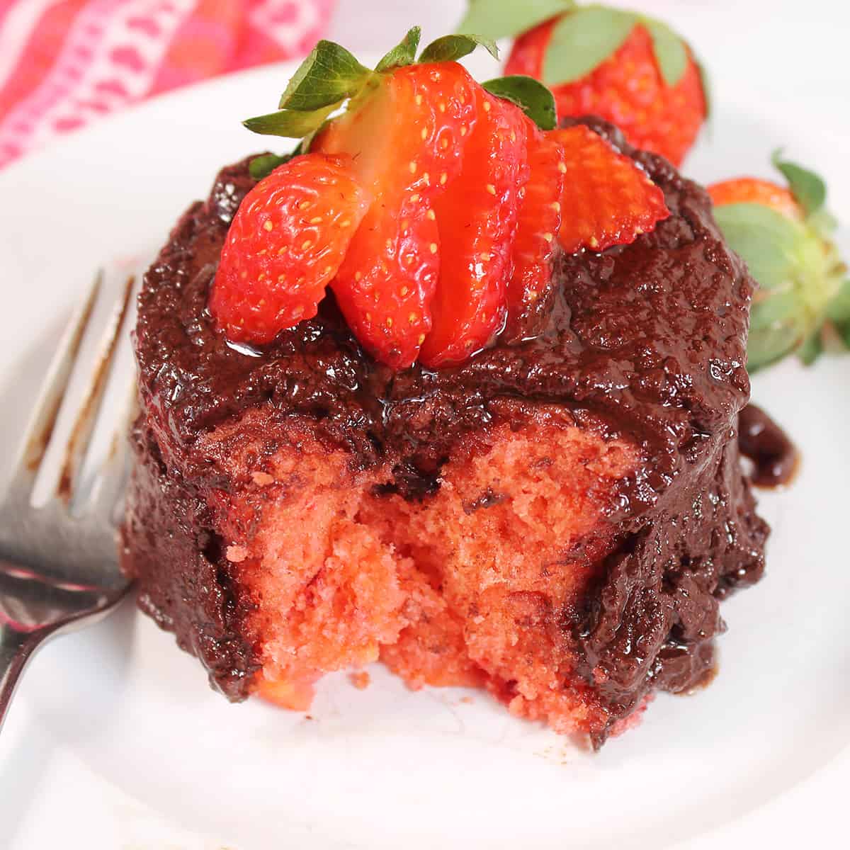 Bite taken out of microwave mug cake showing moist interior.