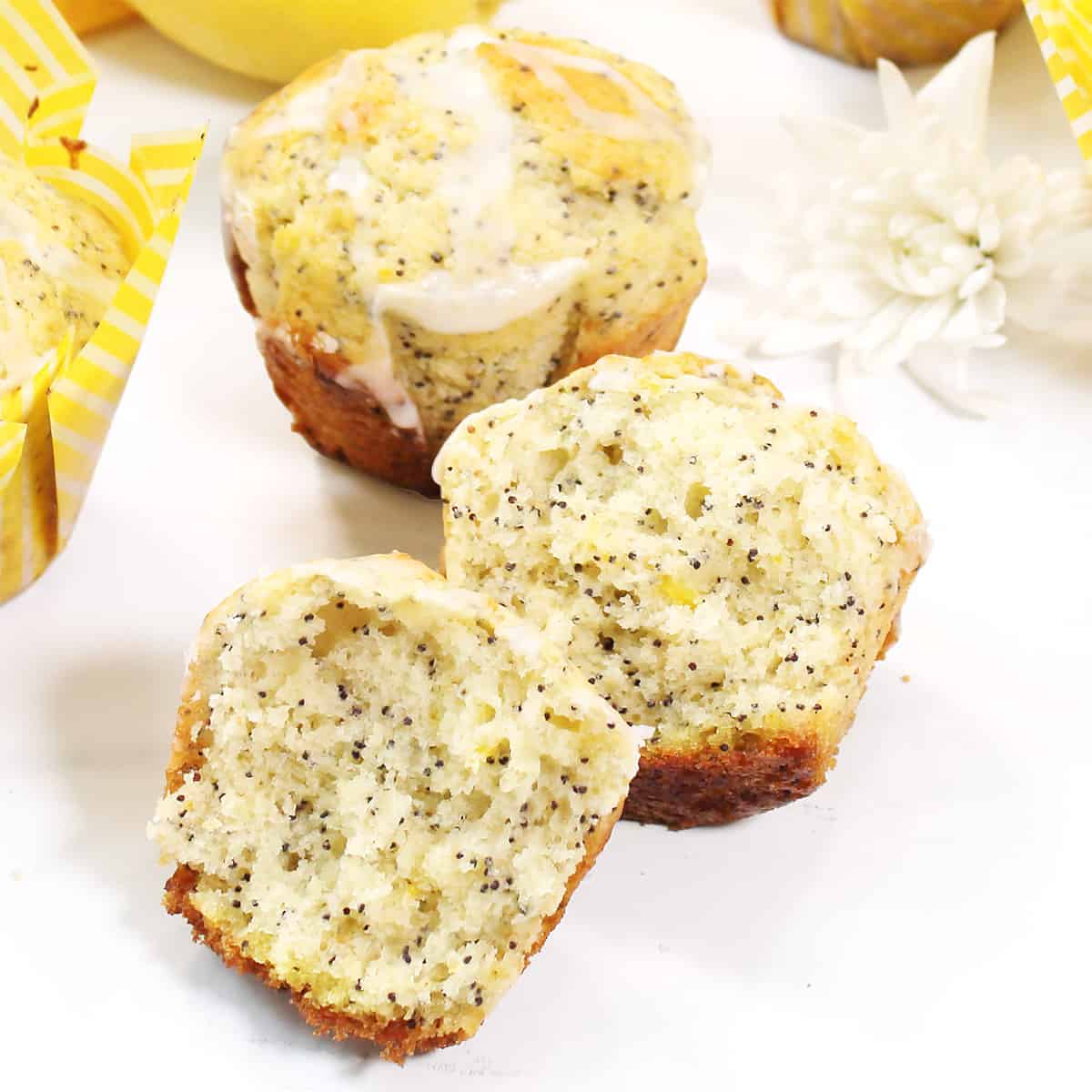 Closeup of halved muffin on white table.