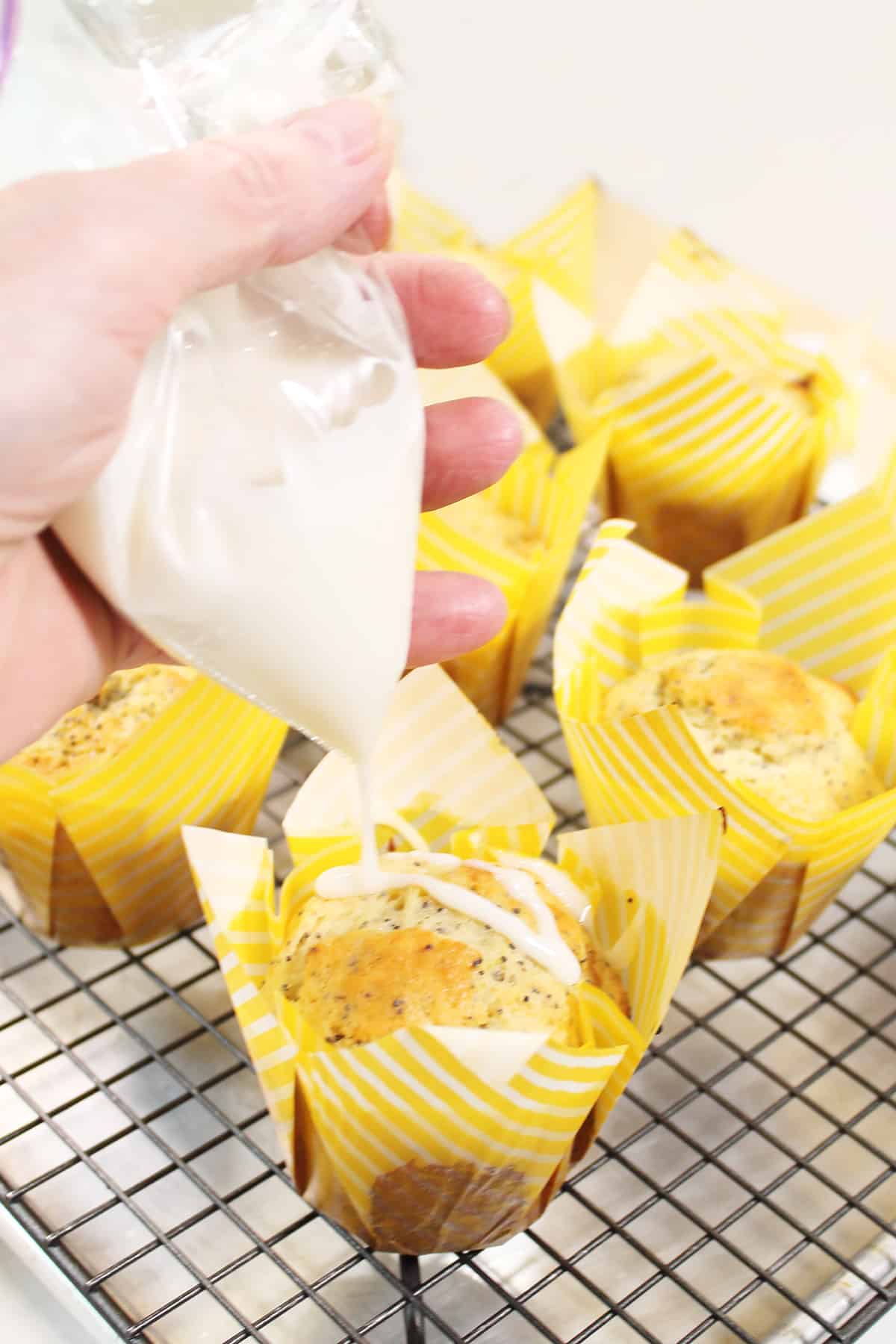 Drizzling muffins with lemon glaze.