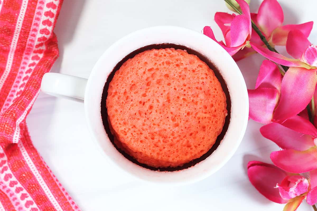 Microwaved mug cake in white mug.