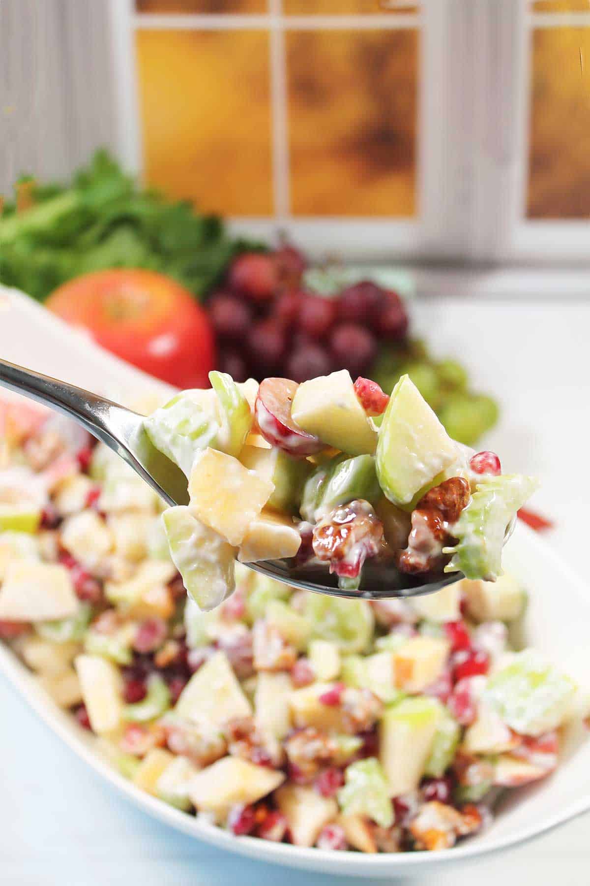 Spoonful of waldorf salad with yogurt.