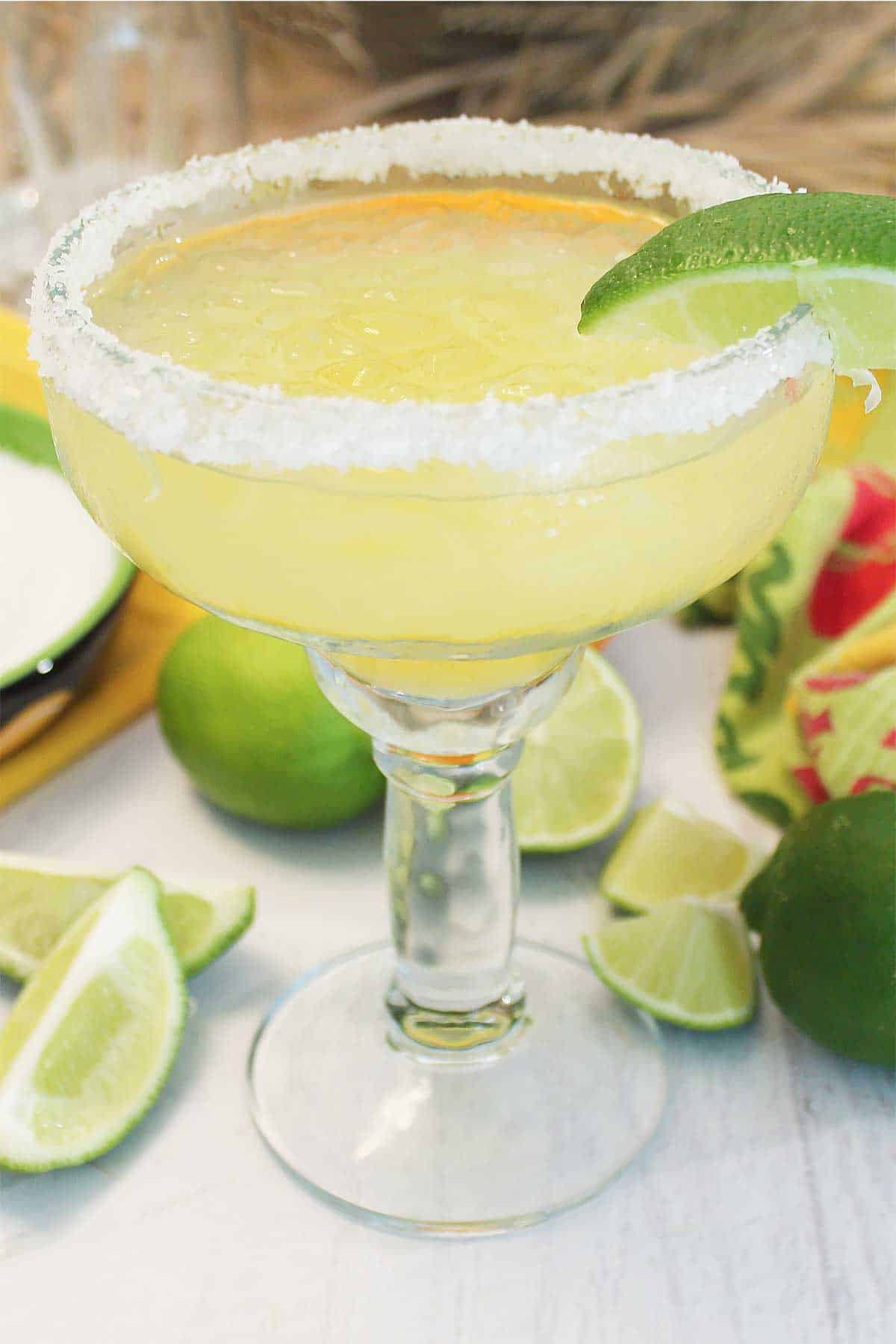 Margarita on the rocks in salted rim margarita glass.