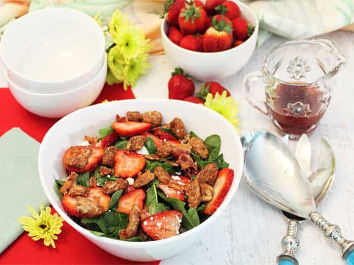Spinach Strawberry Salad with Candied Pecans in white bowl