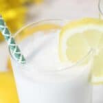 Closeup of top of frozen cocktail with lemon slice.