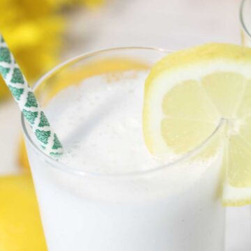 Closeup of top of frozen cocktail with lemon slice.