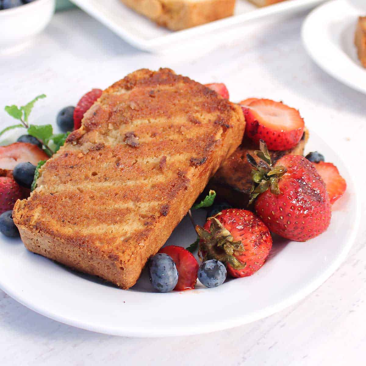 Closeup of crusty grilled pound cake with grilled strawberries.