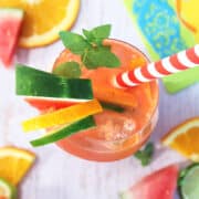 Overhead closeup of white sangria with fruit around it.