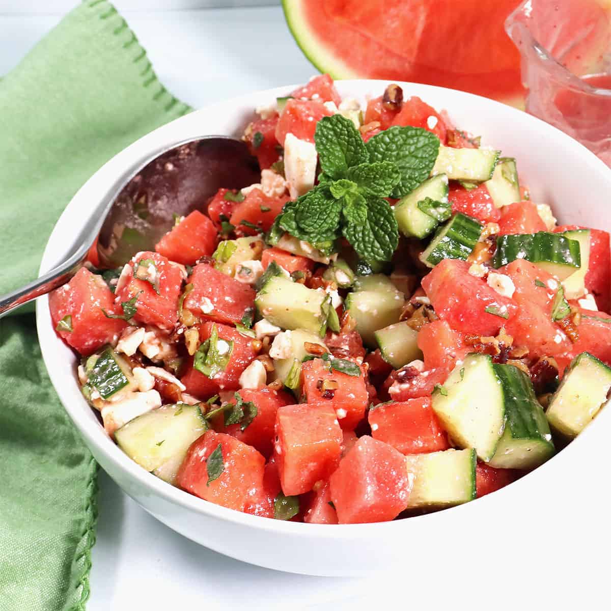 Bowl of Watermelon Cucumber Mint Salad in bowl with spoon.