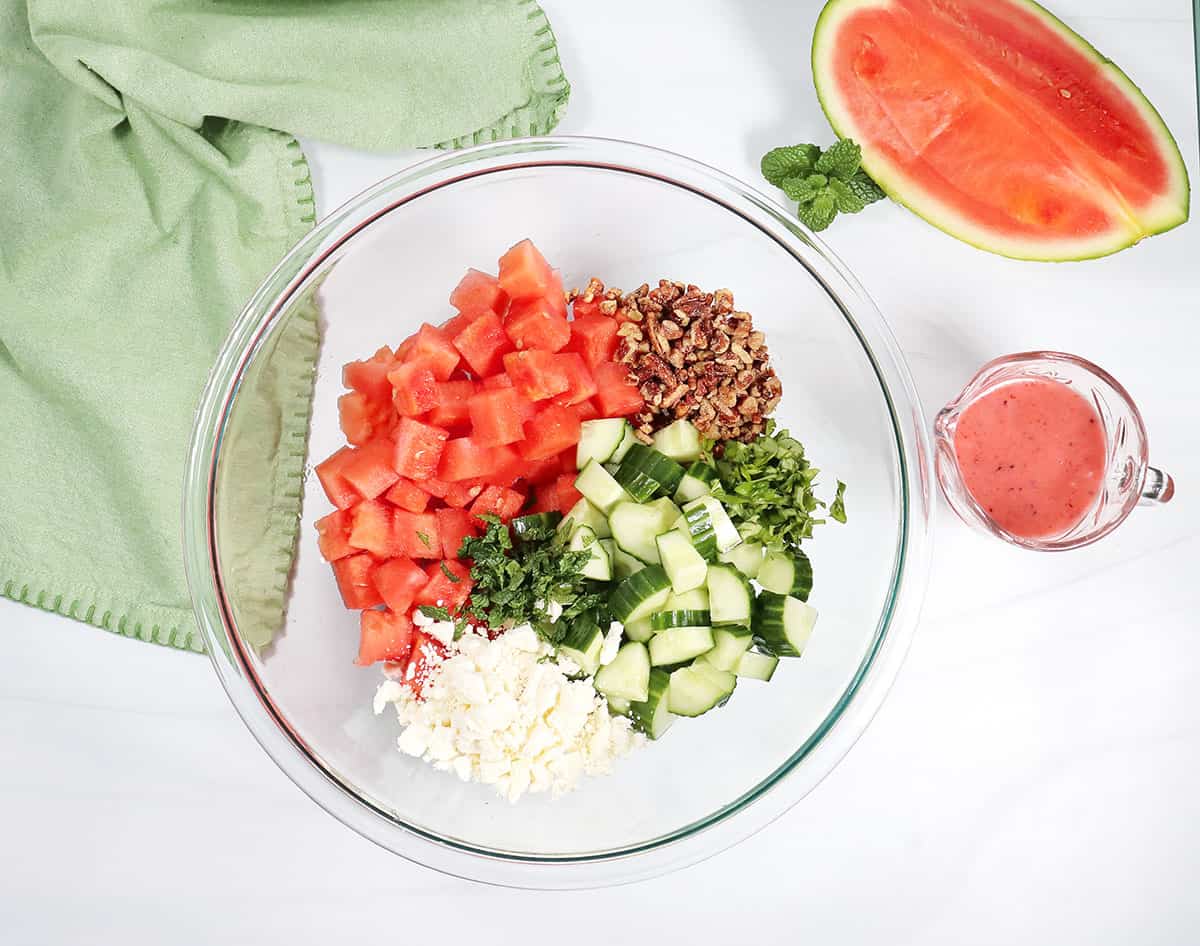Ingredients for watermelon salad in bowl.