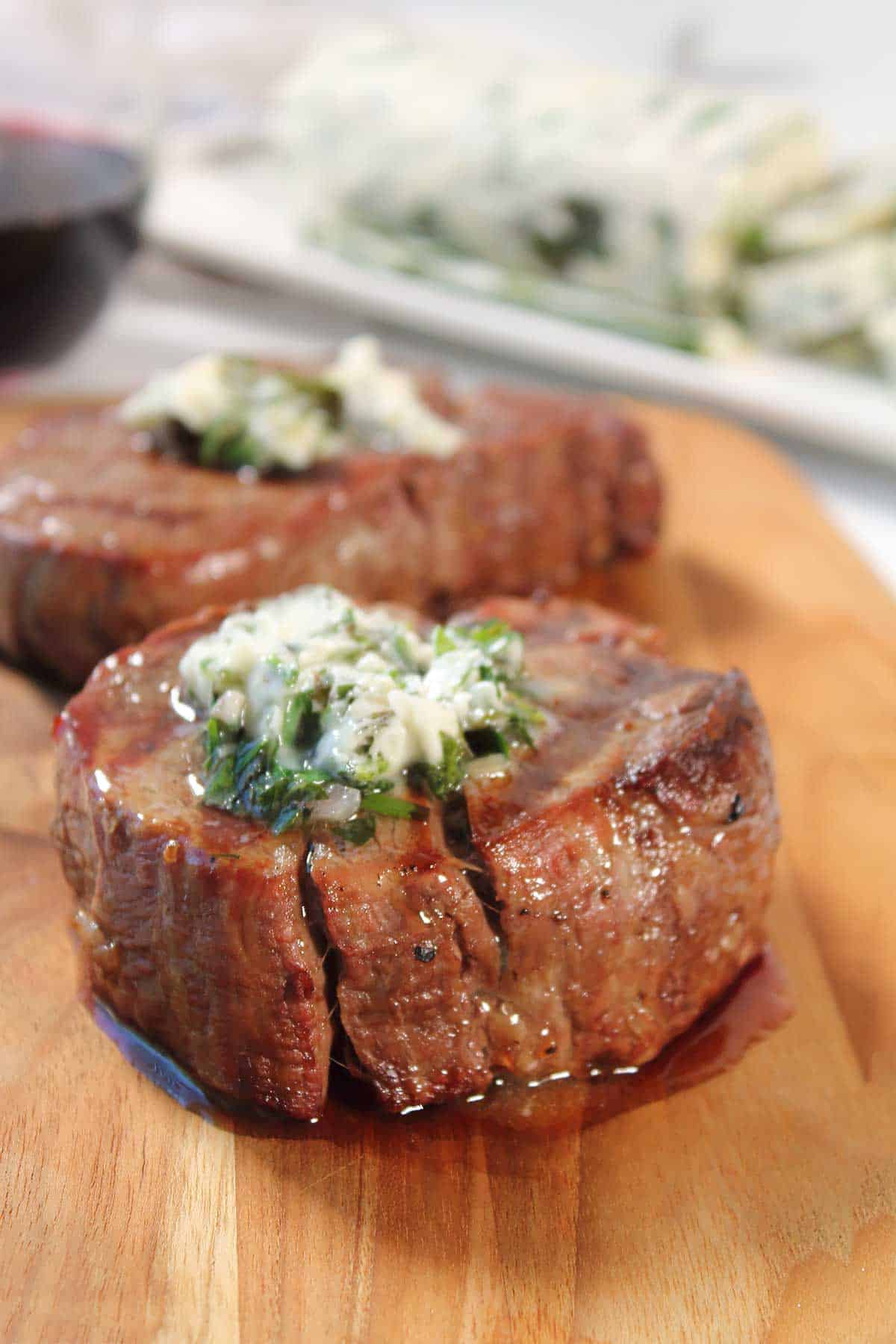 Grilled steak topped with a pat of garlic herb butter.