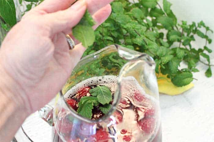 Raspberry Mint Iced Tea adding mint