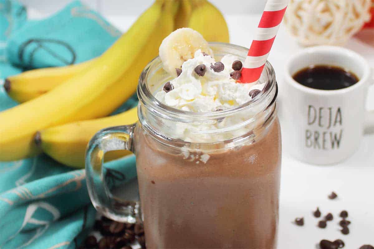 Top the smoothie with whipped cream, chocolate chips and a straw.