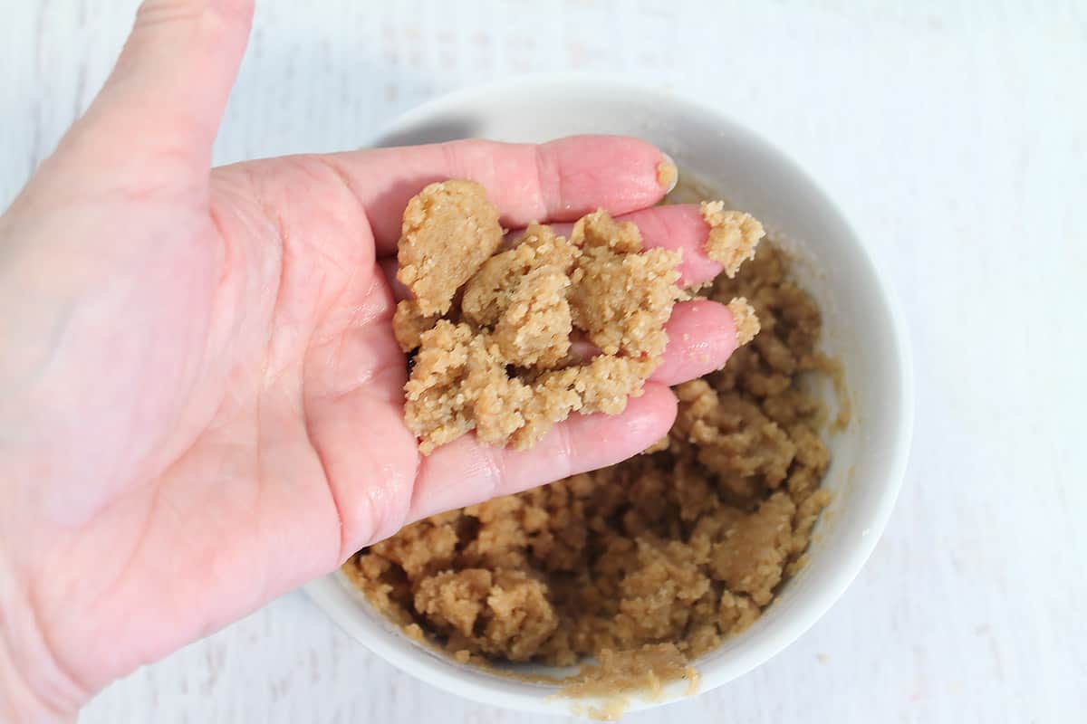 Holding mixed crumb mixture showing texture.