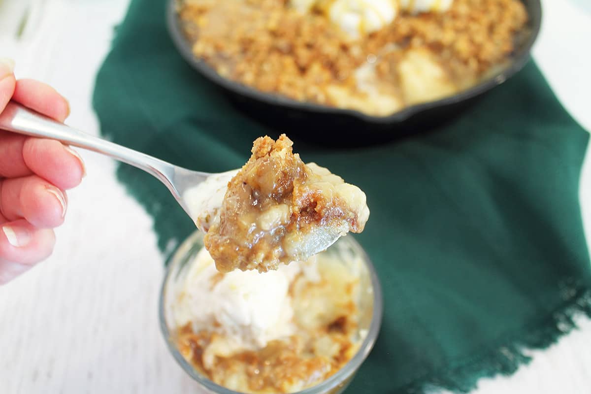 Spoonful of dessert over serving bowl.