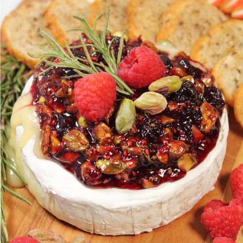 Closeup of air fryer baked brie on serving board.