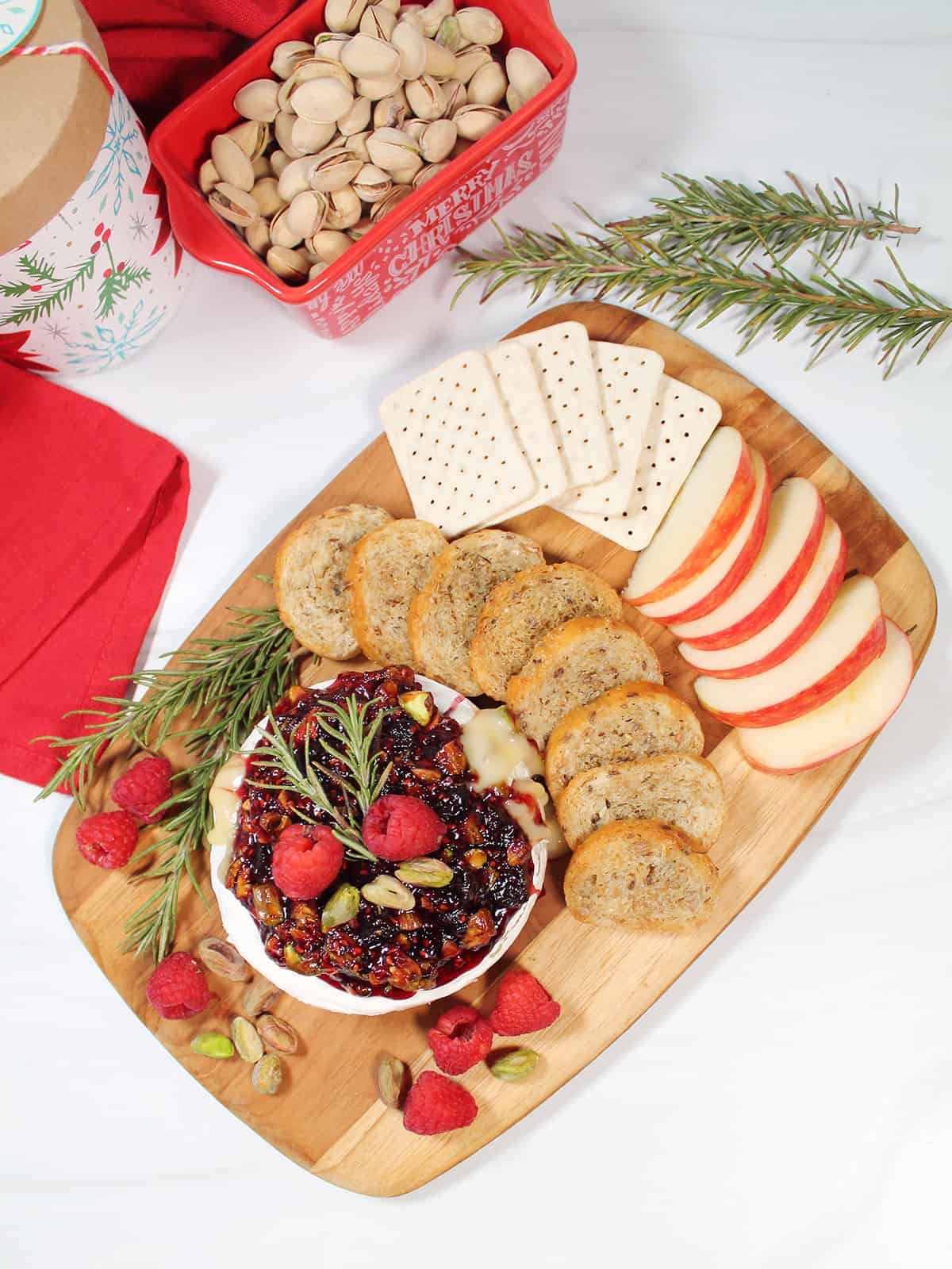 Air fryer baked brie on serving board with dippers.