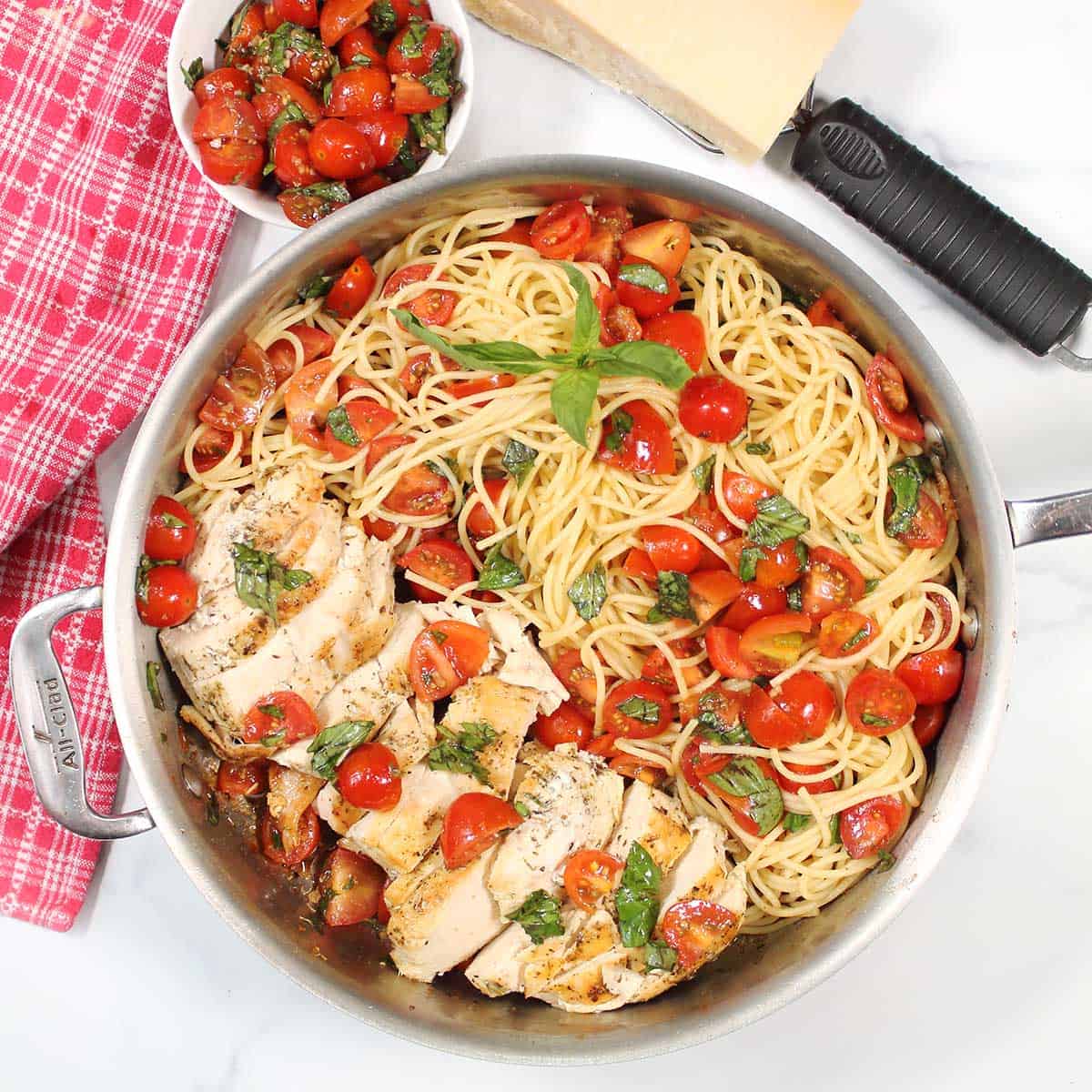 Overhead of skillet with chicken bruschetta pasta.