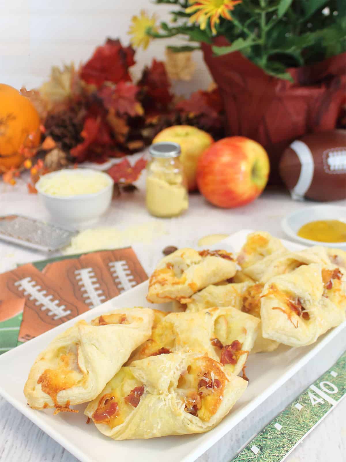 Plated cheesy apple bacon bundles.