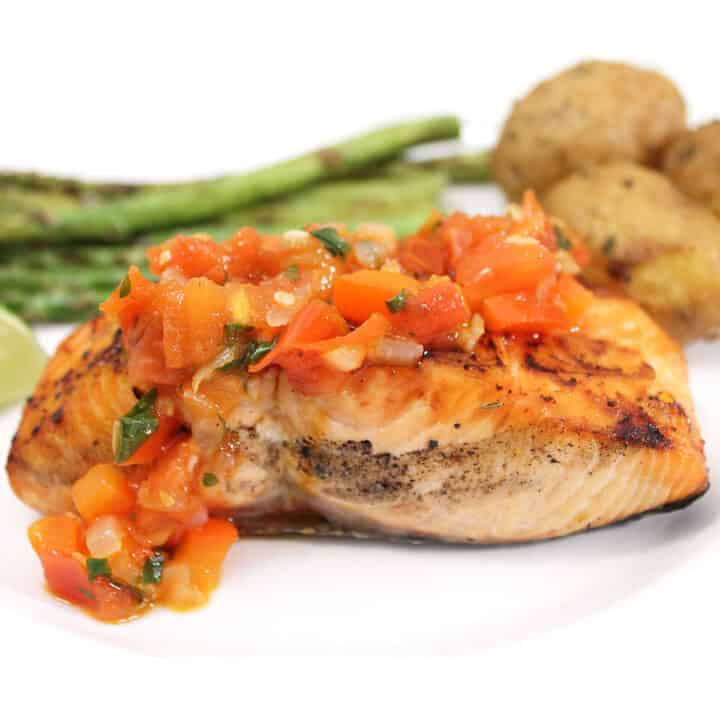 Grilled Salmon with Red Pepper Sauce plated closeup.
