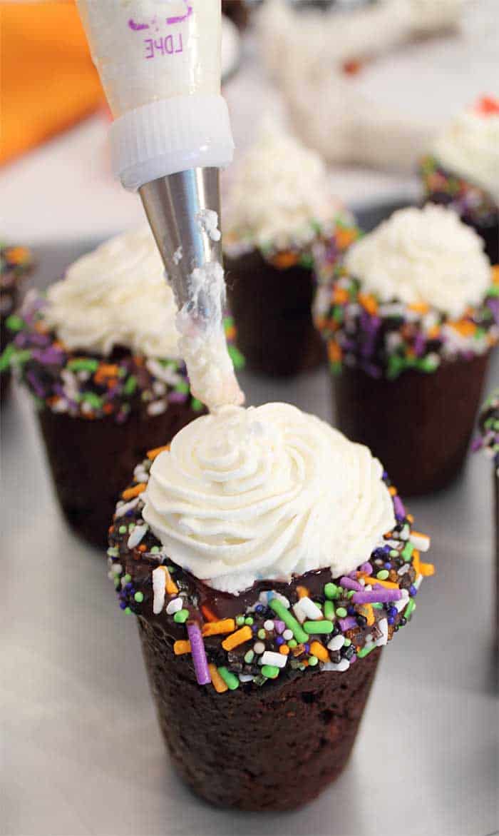 Halloween Chocolate Cherry Cookie Shots putting on frosting