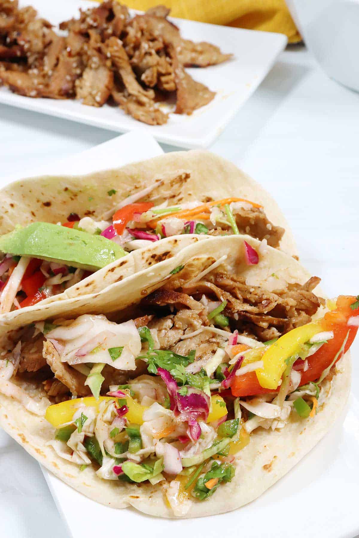 Bulgogi pork stuffed into tortillas with Asian slaw.