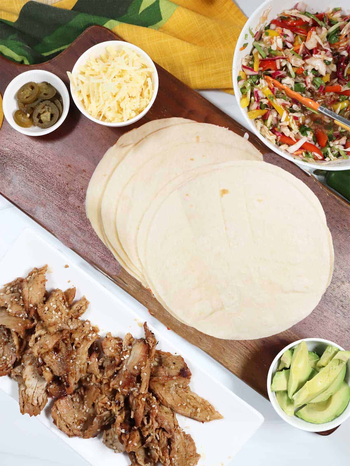 Taco sides with tortillas, bulgogi pork and slaw.
