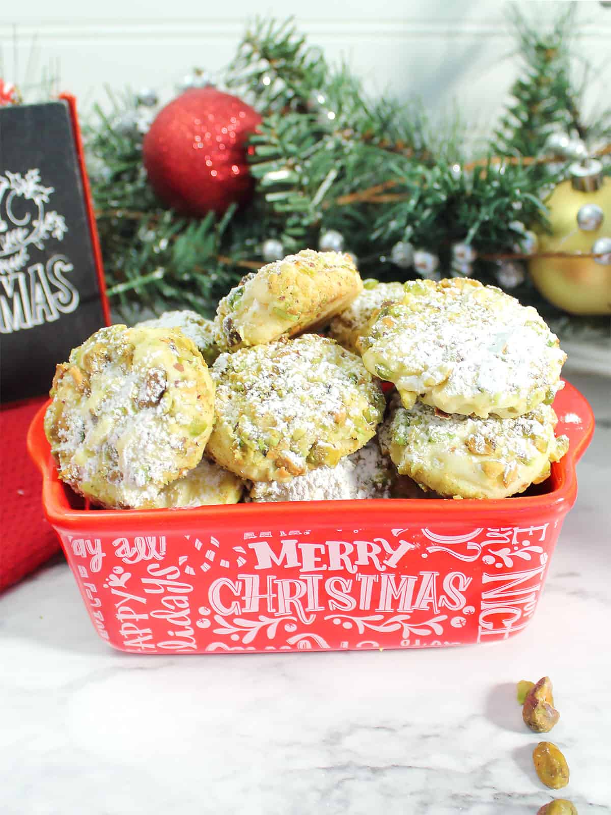 Pistachio Shortbread Cookies in red Christmas dish.