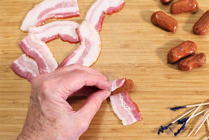 Wrapping little smokie with bacon