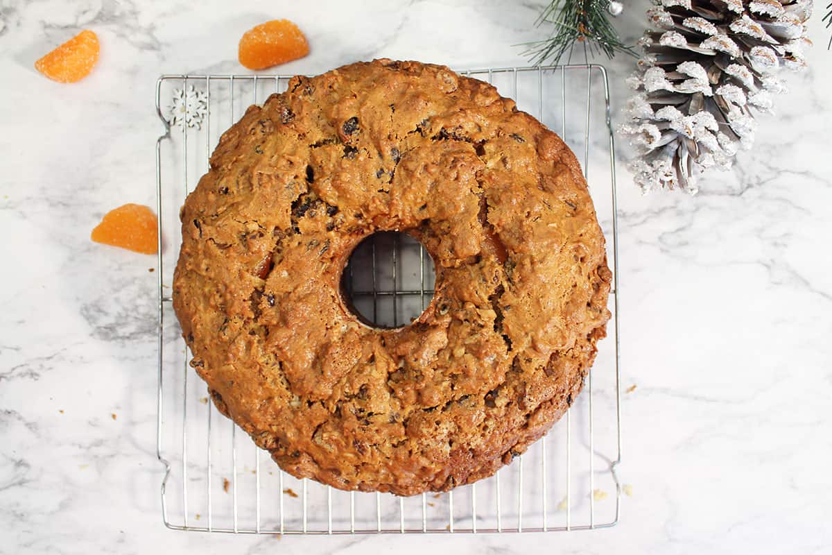 Fruit cake cooling on wire rack.
