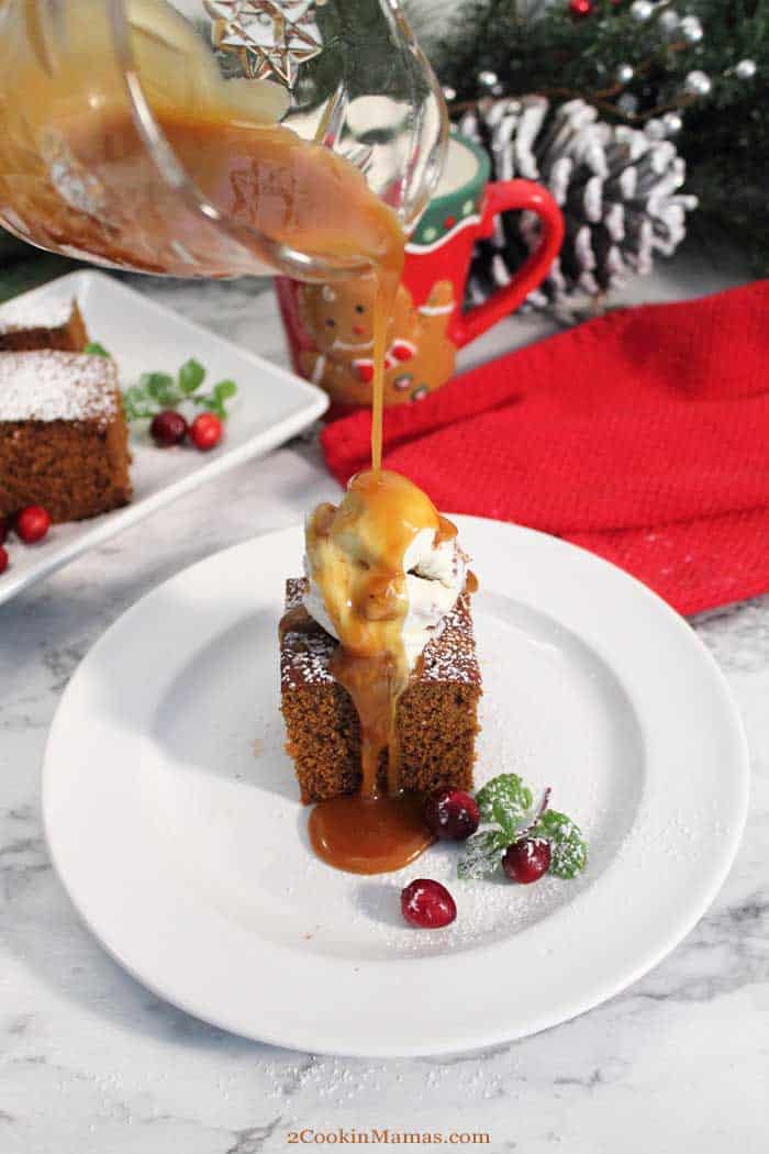 Homemade Spicy Gingerbread pouring caramel tall | 2 Cookin Mamas Our Gingerbread quick bread is full of rich molasses flavor & spiced up with plenty of ginger & cinnamon. Sure to be a favorite for breakfast or dessert! #gingerbread #breakfastbread #quickbread #dessert