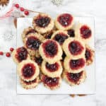 Overhead of plateful of jam thumbprint cookies.