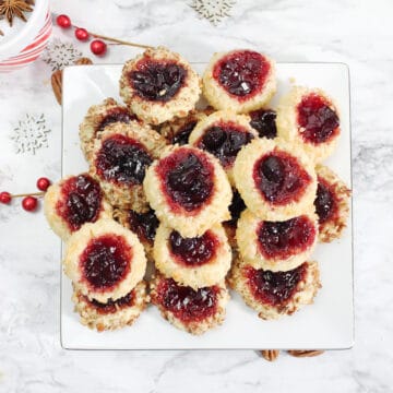Overhead of plateful of jam thumbprint cookies.