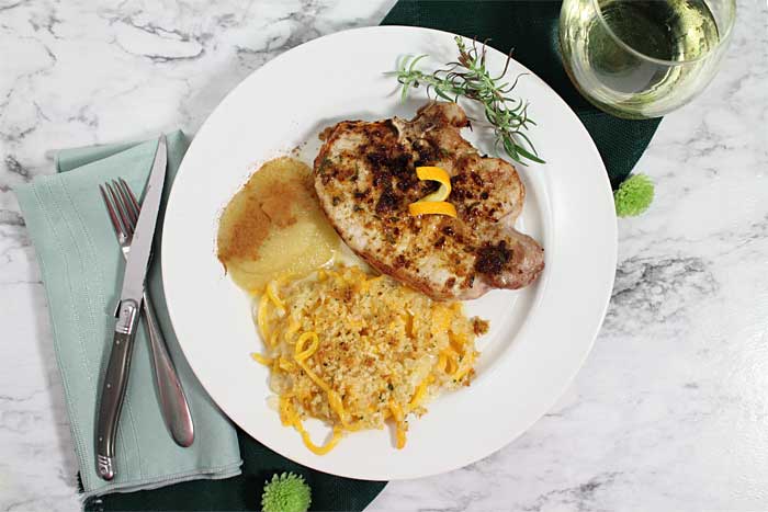 Overhead of Pork Chops dinner on green napkin.