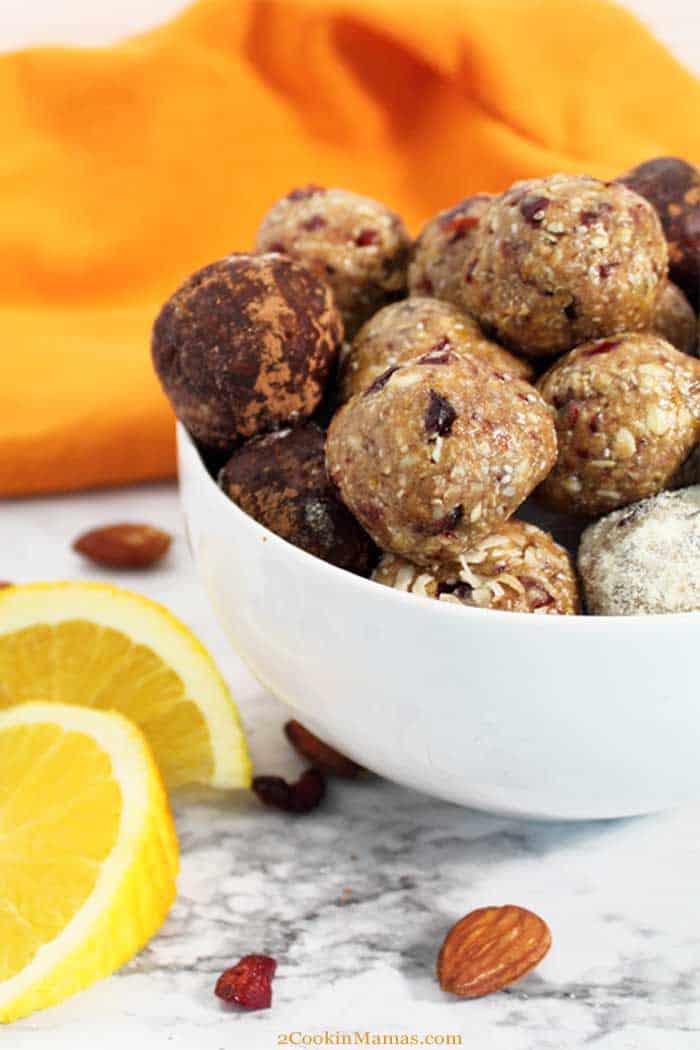 Cranberry Orange Energy Balls tall | 2 Cookin Mamas Cranberry Orange Energy Balls are filled with protein, fiber and antioxidants to refuel you after your workout or give you a quick on-the-go breakfast for rushed mornings. Packed with oats, almonds, cranberries, chia seeds, orange juice and almond butter, they're a tasty bite that's actually healthy. #snack #energyballs #healthy #nobake #protein #oats #lowcarb #almondbutter #recipe #cranberries #chiaseeds #almonds #glutenfree