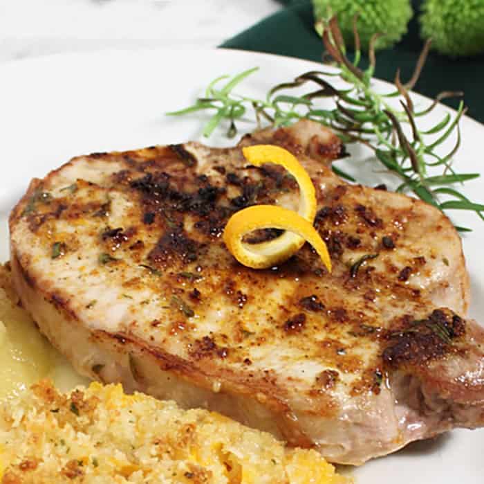 Plated air fryer pork chops with sides.